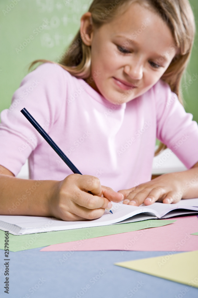 Close-up of school girl writing in notebook Close-up of school girl writing in notebook