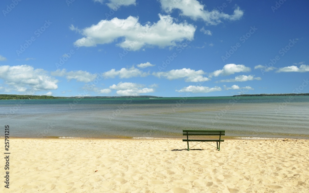 lake Michigan beach with bench and cloudy sky lake Michigan beach with bench and cloudy sky
