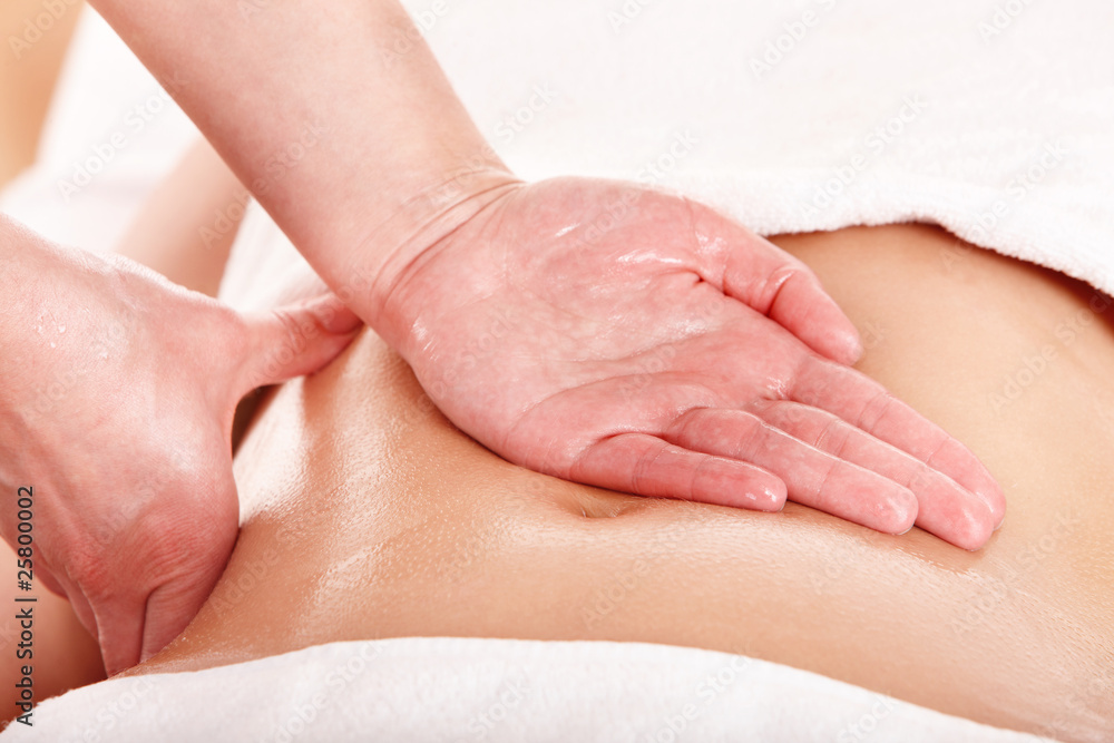Young woman having stomach massage. Young woman having stomach massage.