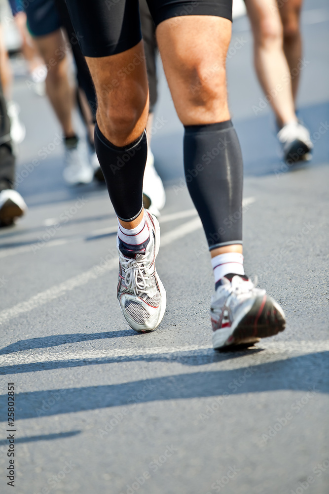 Man running in city marathon - motion blur