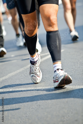 Man running in city marathon - motion blur
