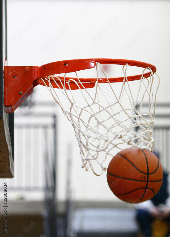 Fototapeta Basketball going through hoop