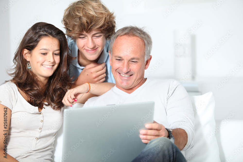 Family at home with laptop computer Family at home with laptop computer