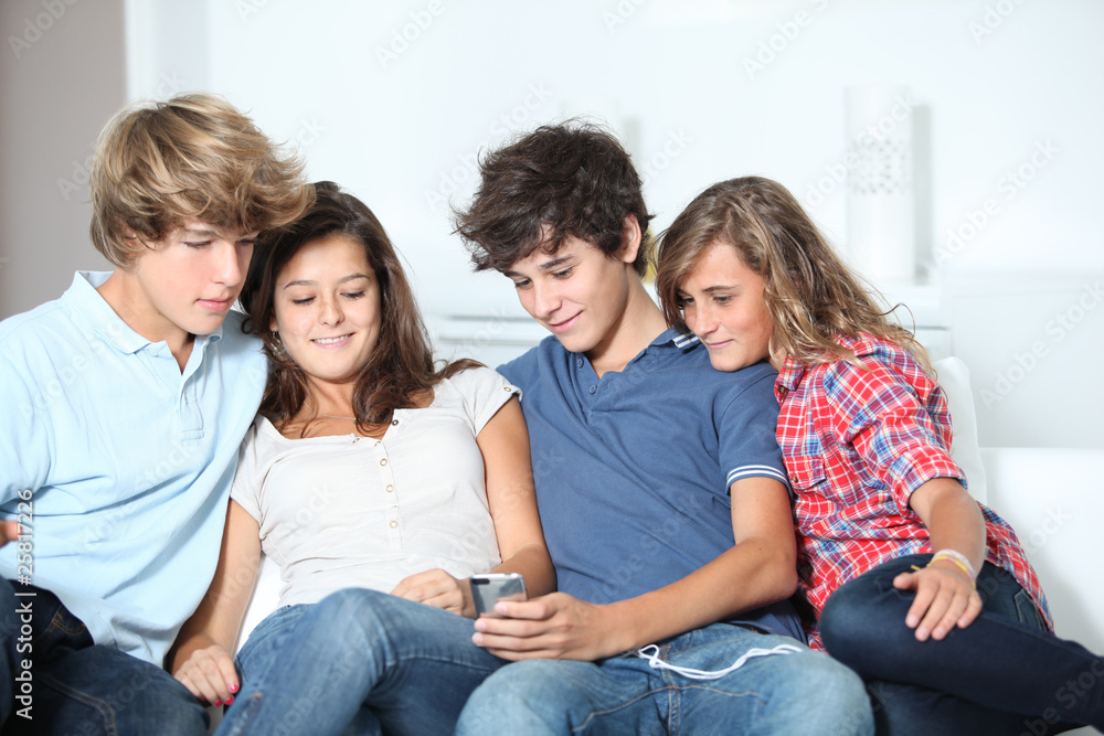 Group of teenagers at home with music player Group of teenagers at home with music player