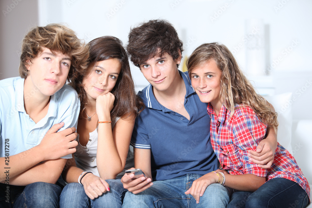 Fototapeta premium Group of teenagers at home with music player