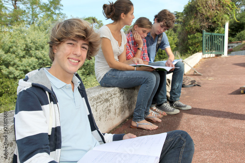 Teenagers studying outside the class © goodluz