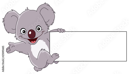 Koala climbing a sign