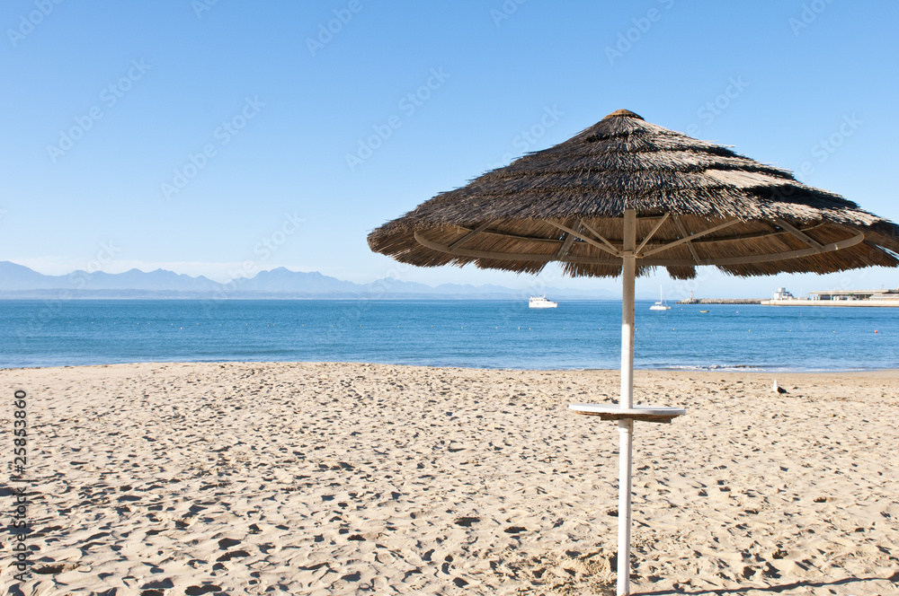 Thatched shade on a deserted beach Thatched shade on a deserted beach
