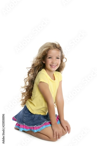 little blond girl smiling portrait on her knees isolated on whit © lunamarina
