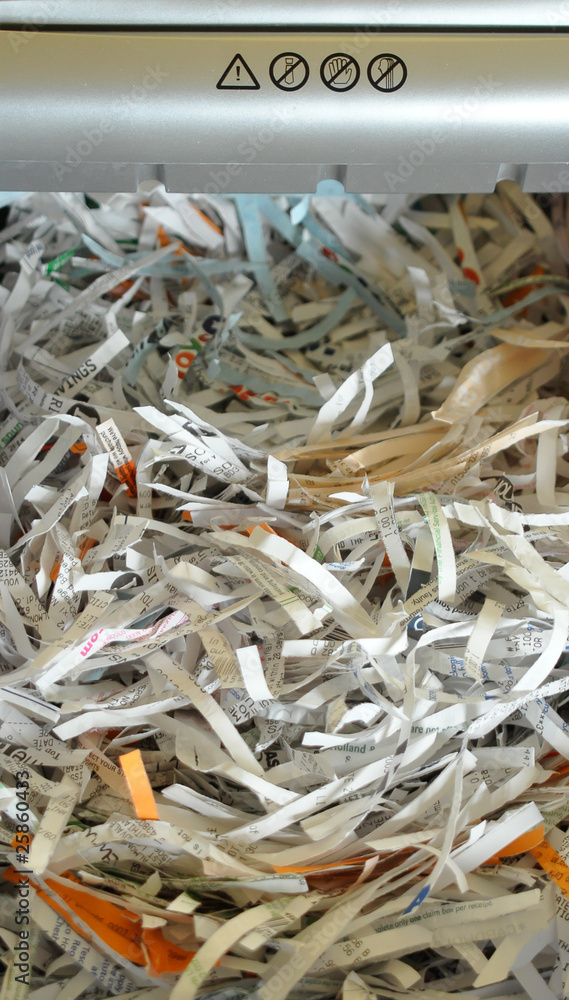 Shredded paper coming out from the shredder Shredded paper coming out from the shredder