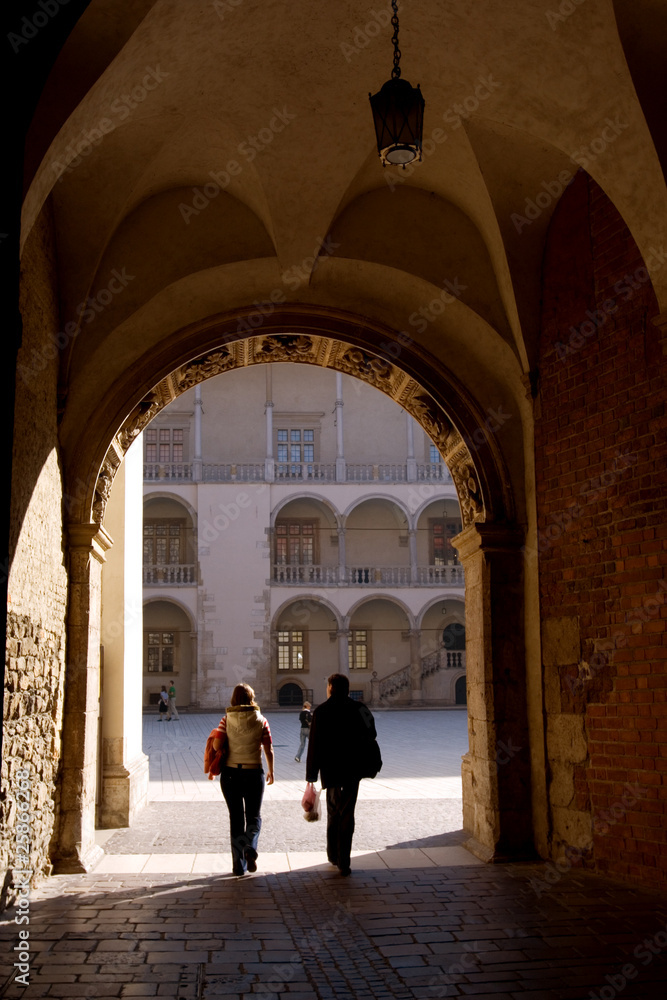 Tourist walking around Wawel royal castle in Krakow, Poland Tourist walking around Wawel royal castle in Krakow, Poland