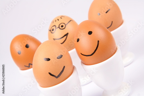Eggs with a smiling faces on white background