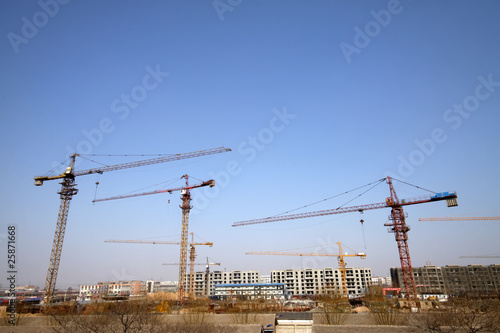 high-rise building and crane