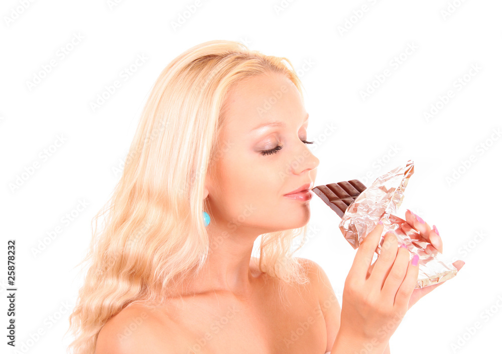 Beautiful young happy smiling woman eating chocolate. Isolated o Beautiful young happy smiling woman eating chocolate. Isolated o