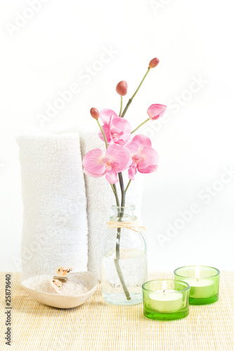 Composition of Pink orchid, towel and two candles
