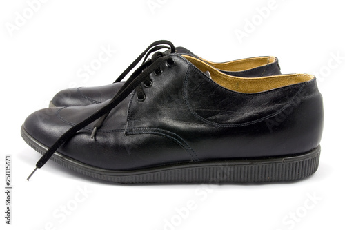 pair of black leather shoes on white background
