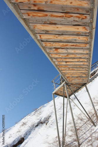 Stairs with landing against a snow slope photo