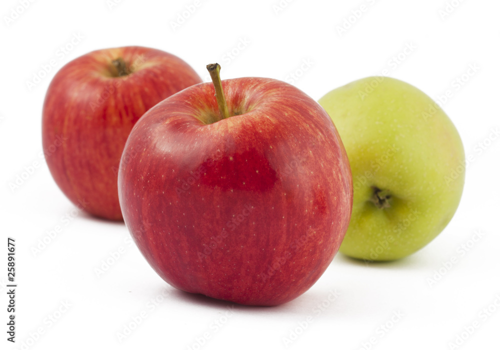 Two red and one green apples on white Two red and one green apples on white