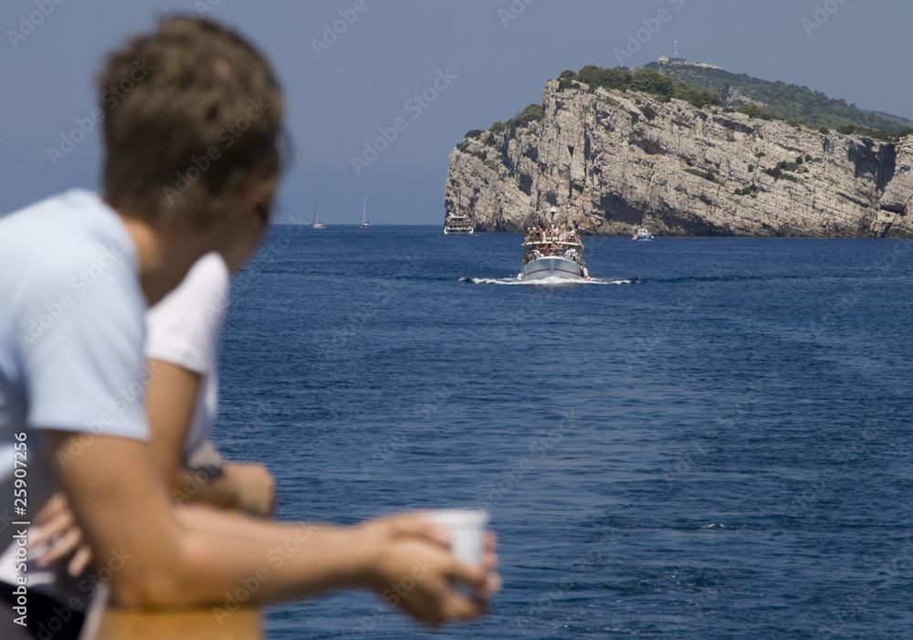 Tourists watching Dugi Otok Cliff at Kornati Islands, Croatia.