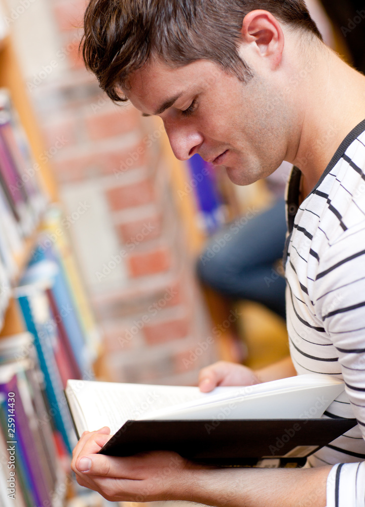 Serious young man reading a book Serious young man reading a book