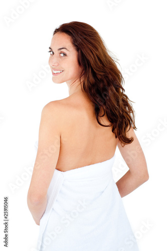 Radiant hispanic woman with a towel on her body smiling at the