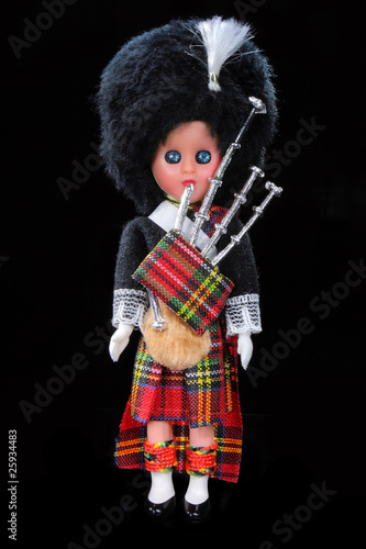 Scottish boy toy isolated on black background