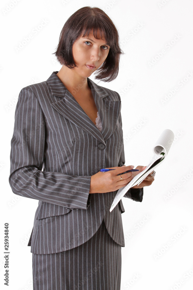 beautiful business woman wrote in a notebook and looks at camera beautiful business woman wrote in a notebook and looks at camera
