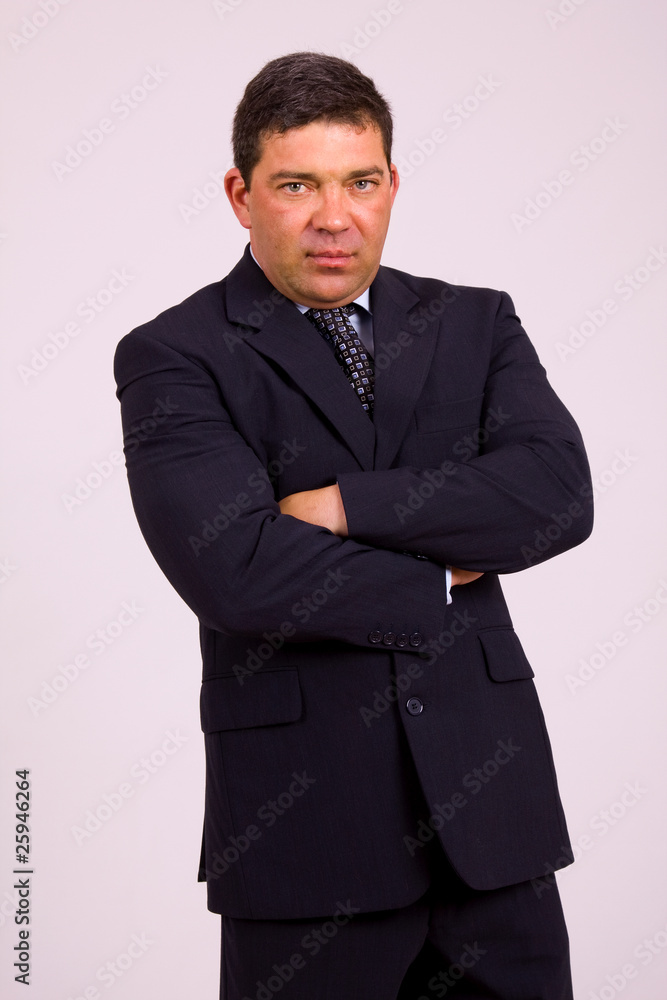Portrait of a mature business man on a grey background Portrait of a mature business man on a grey background