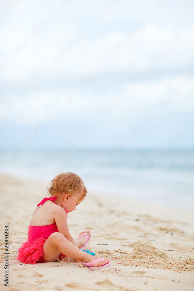 Toddler girl playing with toys at beach Toddler girl playing with toys at beach