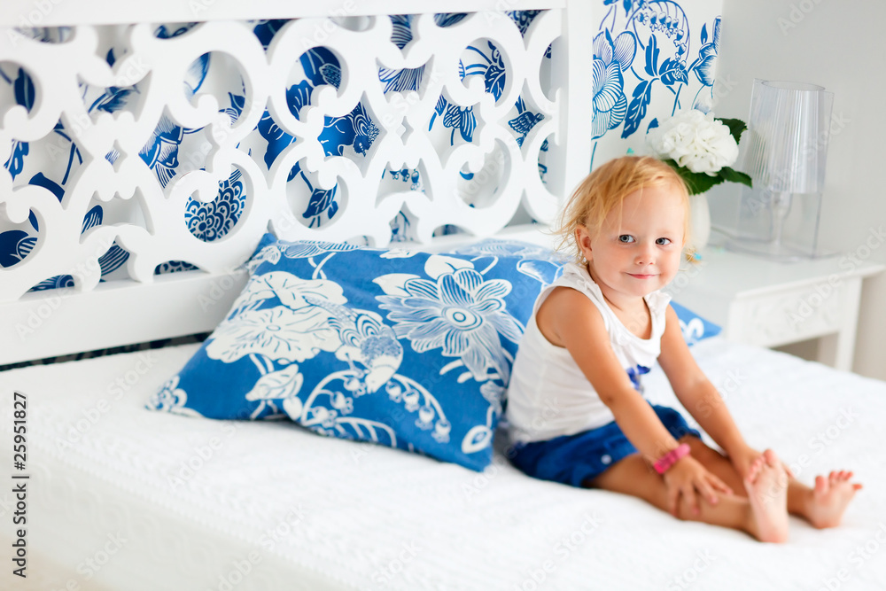 Toddler girl sitting on bed Toddler girl sitting on bed