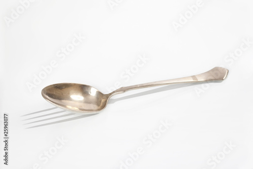Spoon with a fork shape shadow abstract