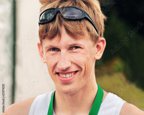 Portrait of the young smiling sportsman
