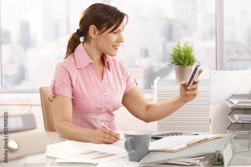 Office worker using mobile phone
