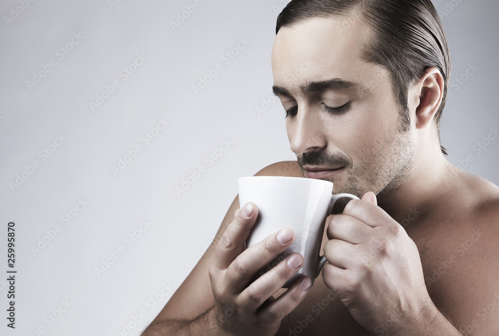 Happy young Caucasian guy having a cup of coffee Happy young Caucasian guy having a cup of coffee