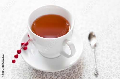 Cup of tea with berries background