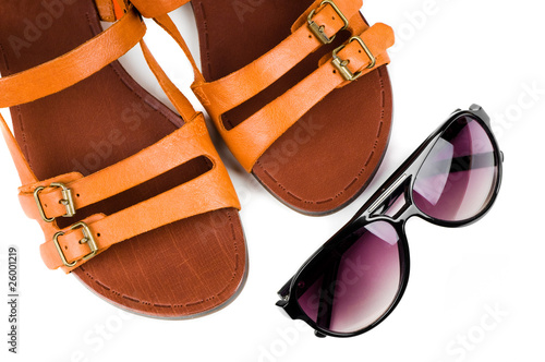 Fashion women sandals and sun glasses isolated on white