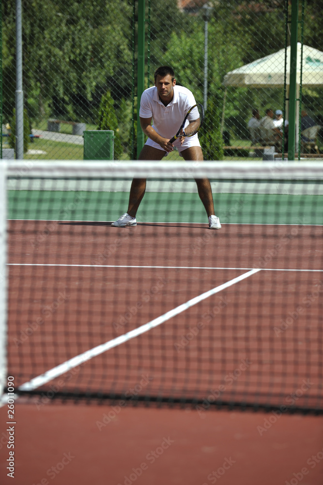 young man play tennis outdoor