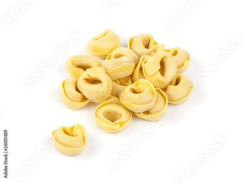 raw tortellini pasta on white background