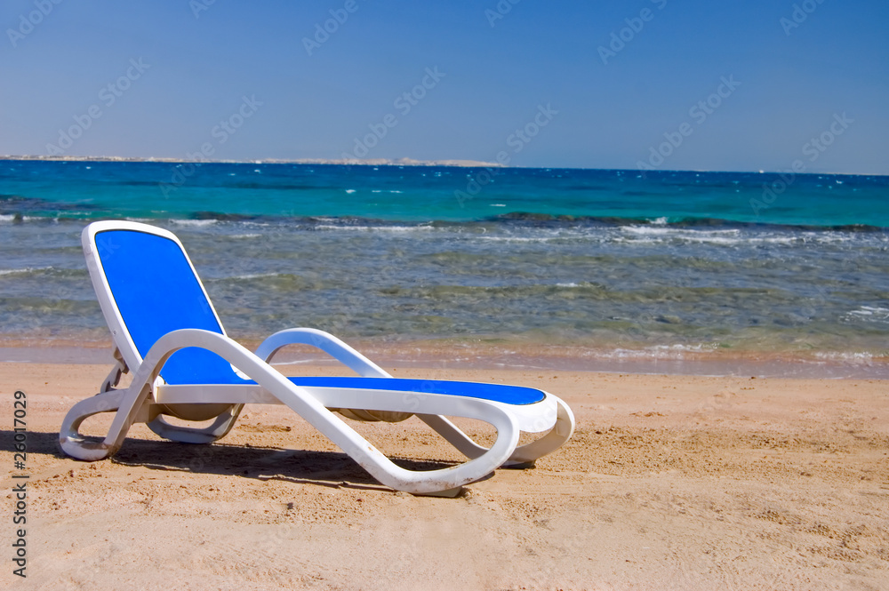 Dark blue chaise lounge at the sea Dark blue chaise lounge at the sea