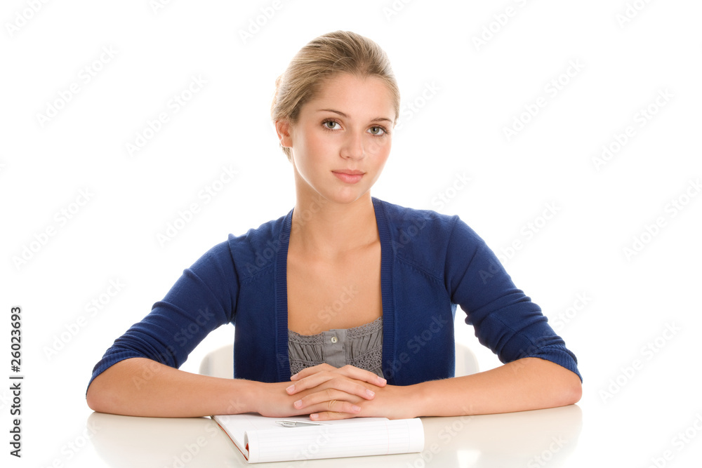 Female student sitting behind desk Female student sitting behind desk