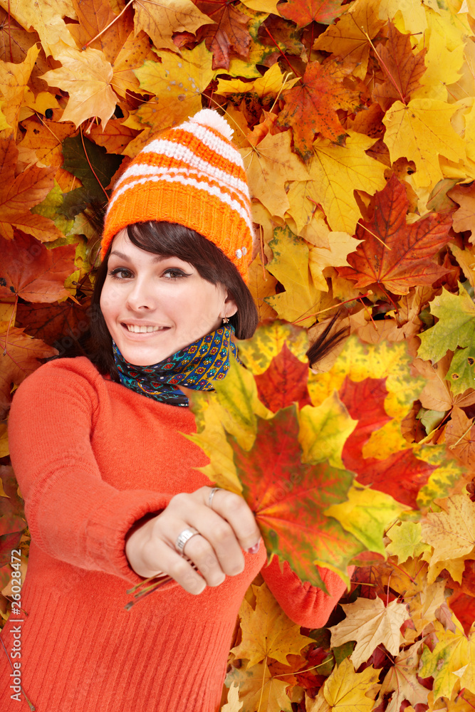 Young woman in autumn orange leaves. Young woman in autumn orange leaves.