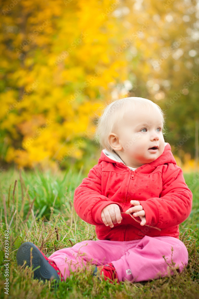 young adorable baby sit on grass under yellow autumn tree young adorable baby sit on grass under yellow autumn tree