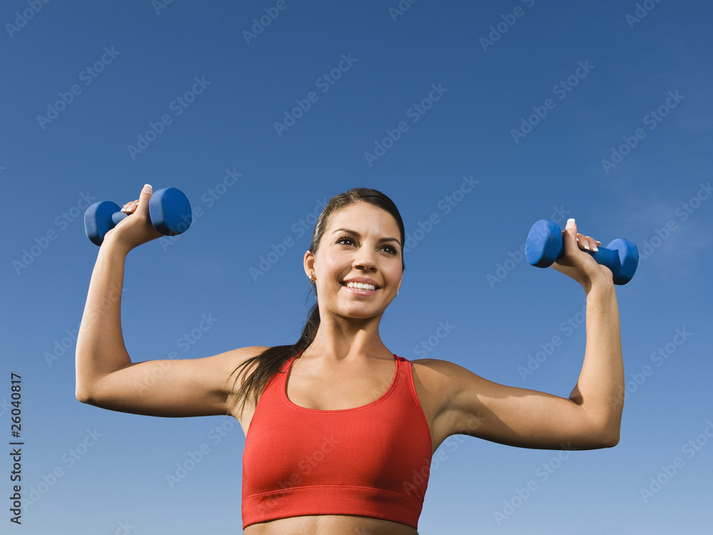 Native American woman lifting hand weights Native American woman lifting hand weights
