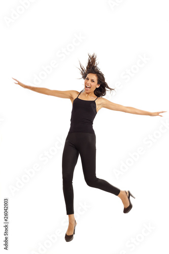 Cute young energetic girl wearing black jumping in air