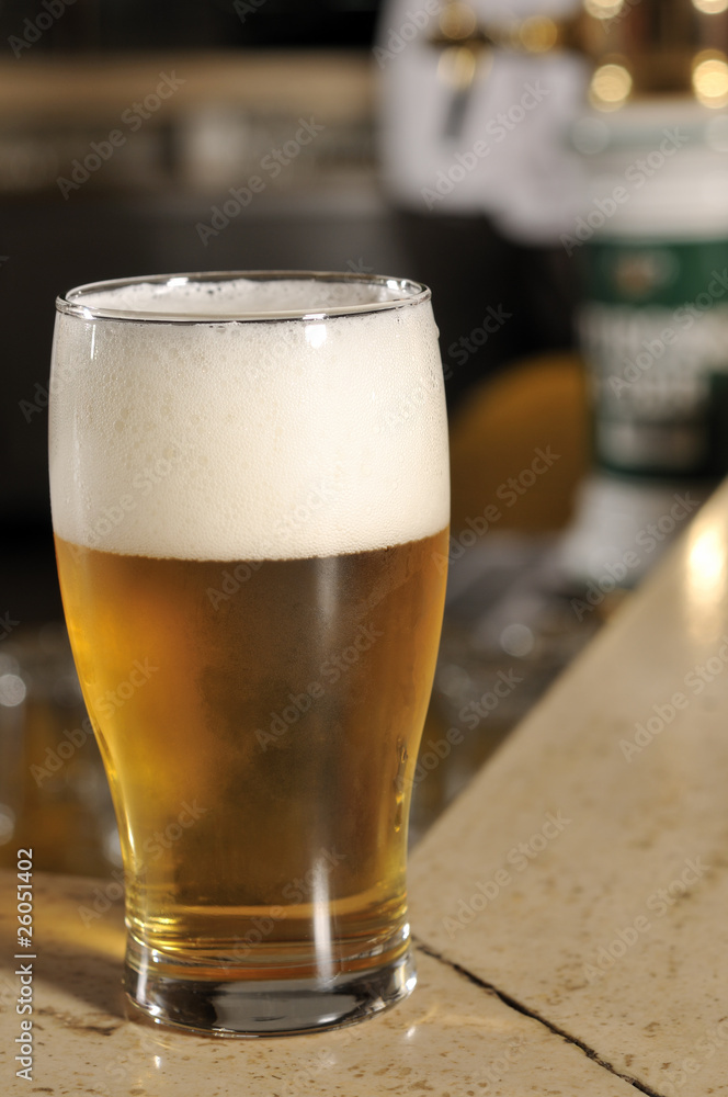 Glass of beer in pub close up