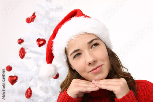 Beautiful young woman wearing santa hat