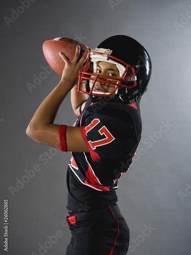 Mixed race quarterback ready to throw football photo