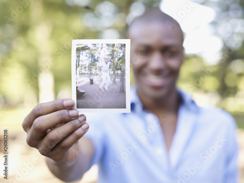 African man holding photograph photo