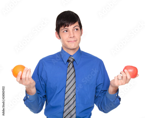 Caucasian businessman comparing apple to orange photo