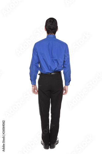 Caucasian businessman standing with arms at sides rear view